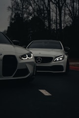 A couple of white cars parked next to each other