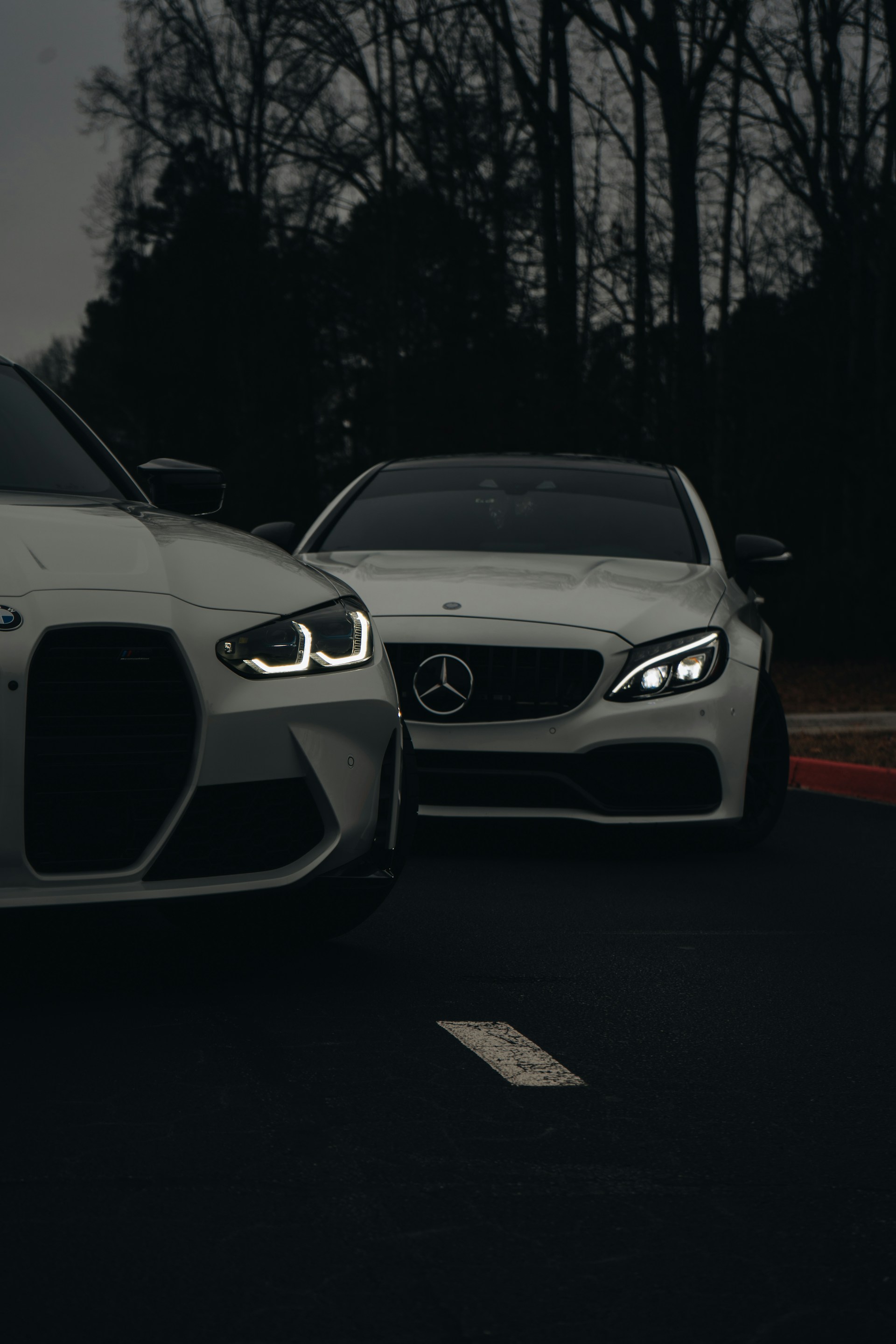 A couple of white cars parked next to each other