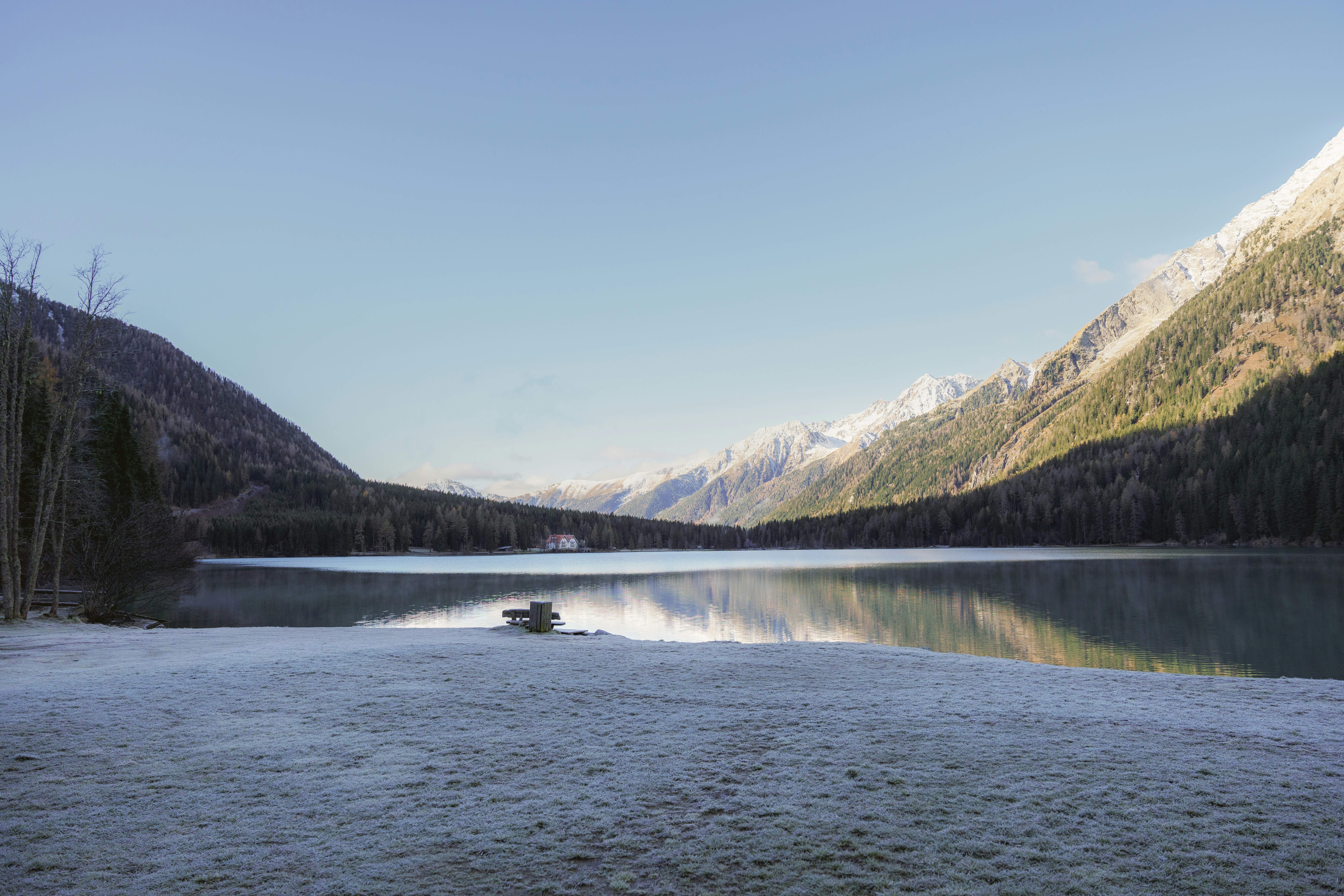 A body of water surrounded by mountains and trees