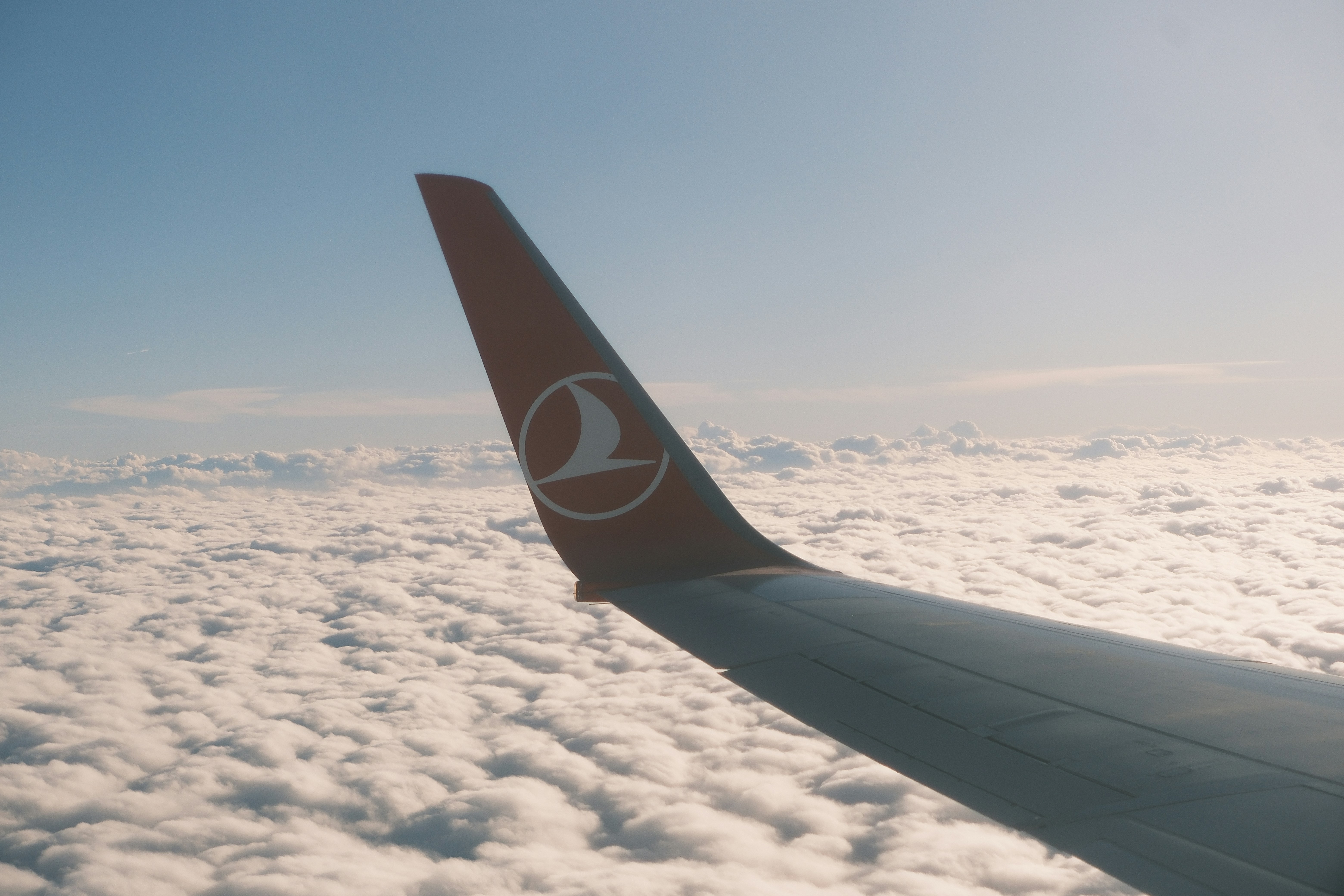 The wing of an airplane flying above the clouds, 
