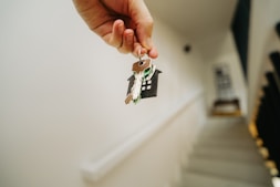 A person holding a house key in their hand
