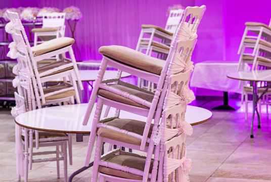A room filled with lots of white tables and chairs