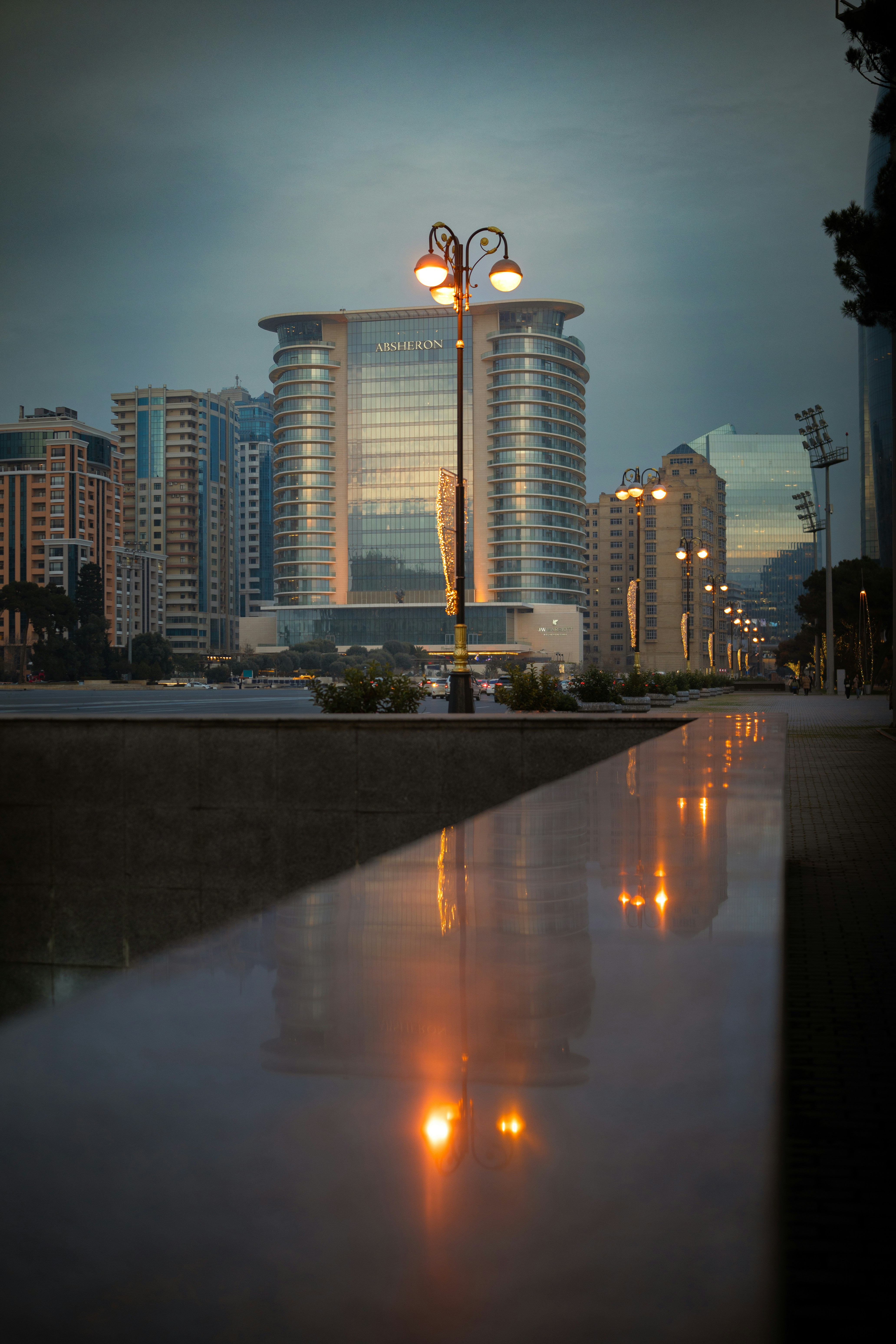 A street light sitting next to a body of water photo – Free City Image ...