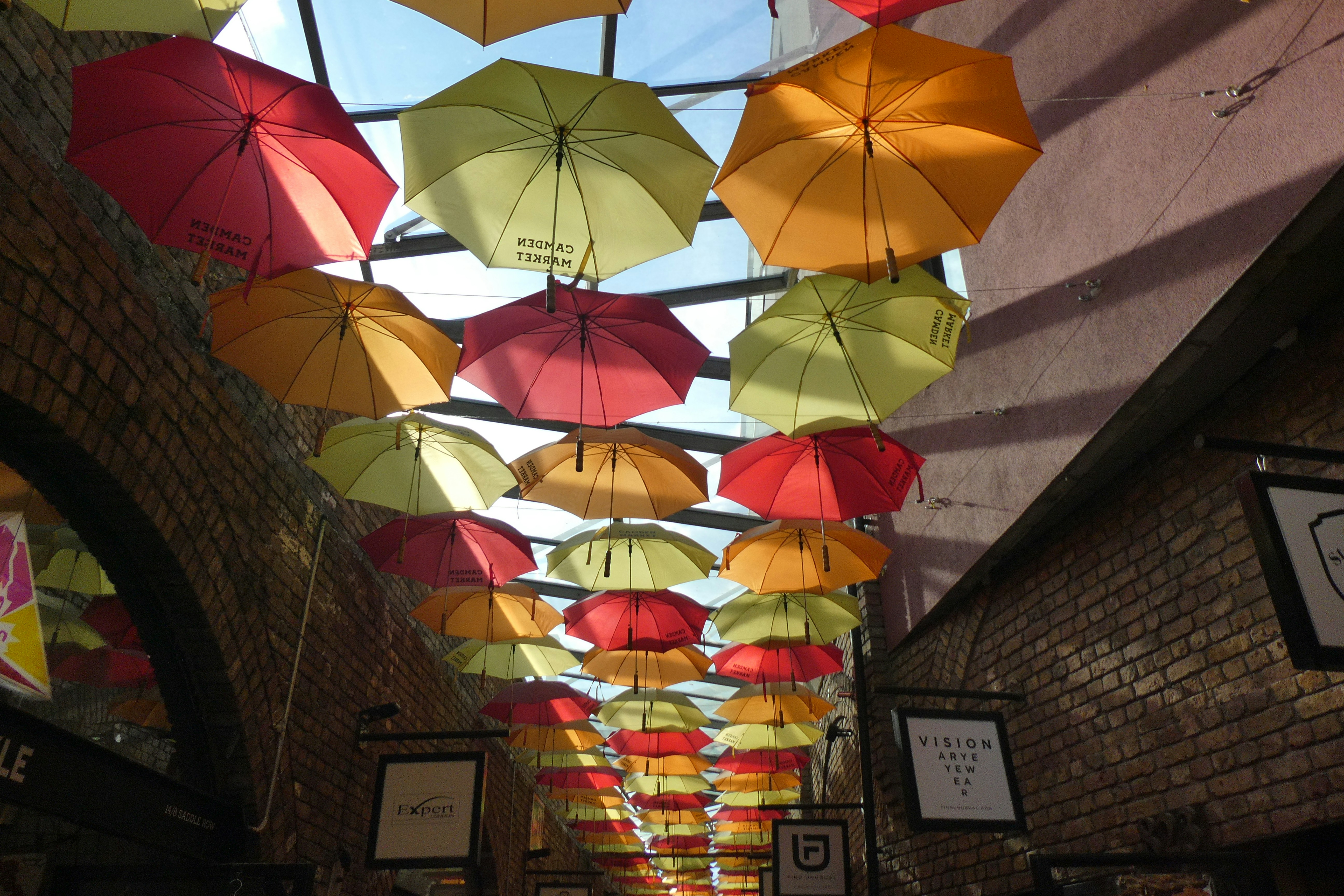 A group of people walking down a street under umbrellas