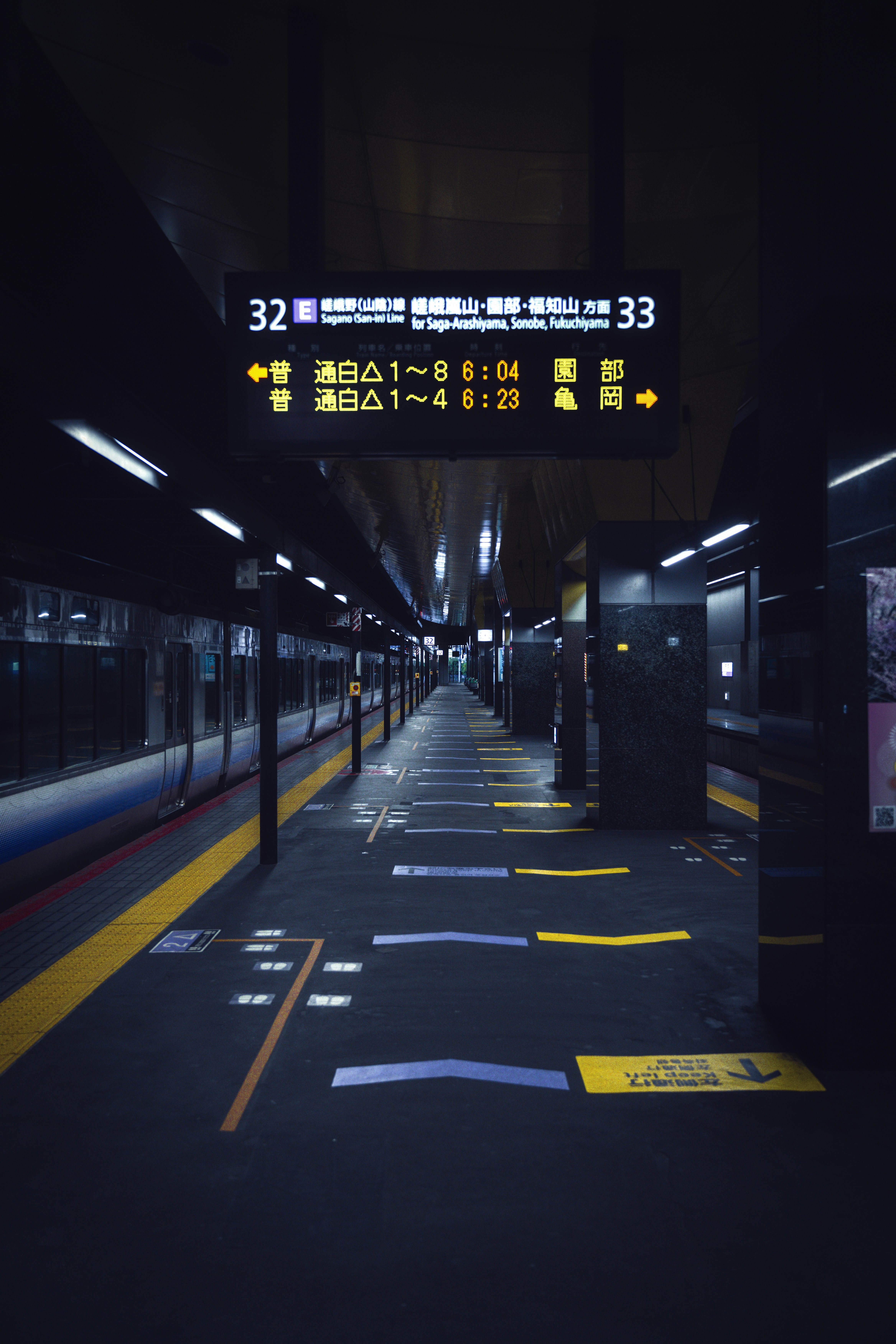 A train station with a train on the tracks