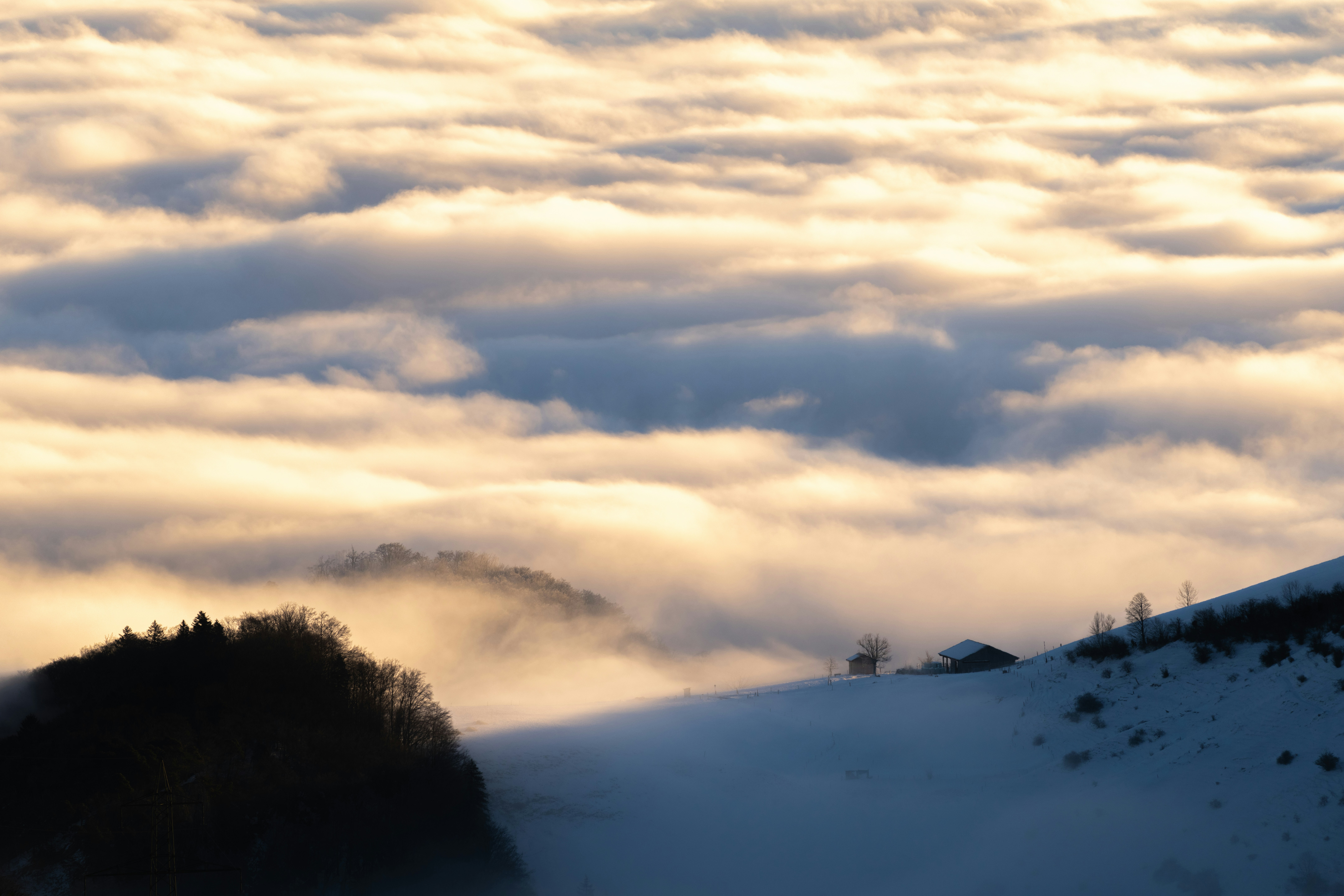 A view of a mountain covered in clouds