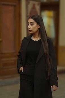A woman with long hair walking down a street