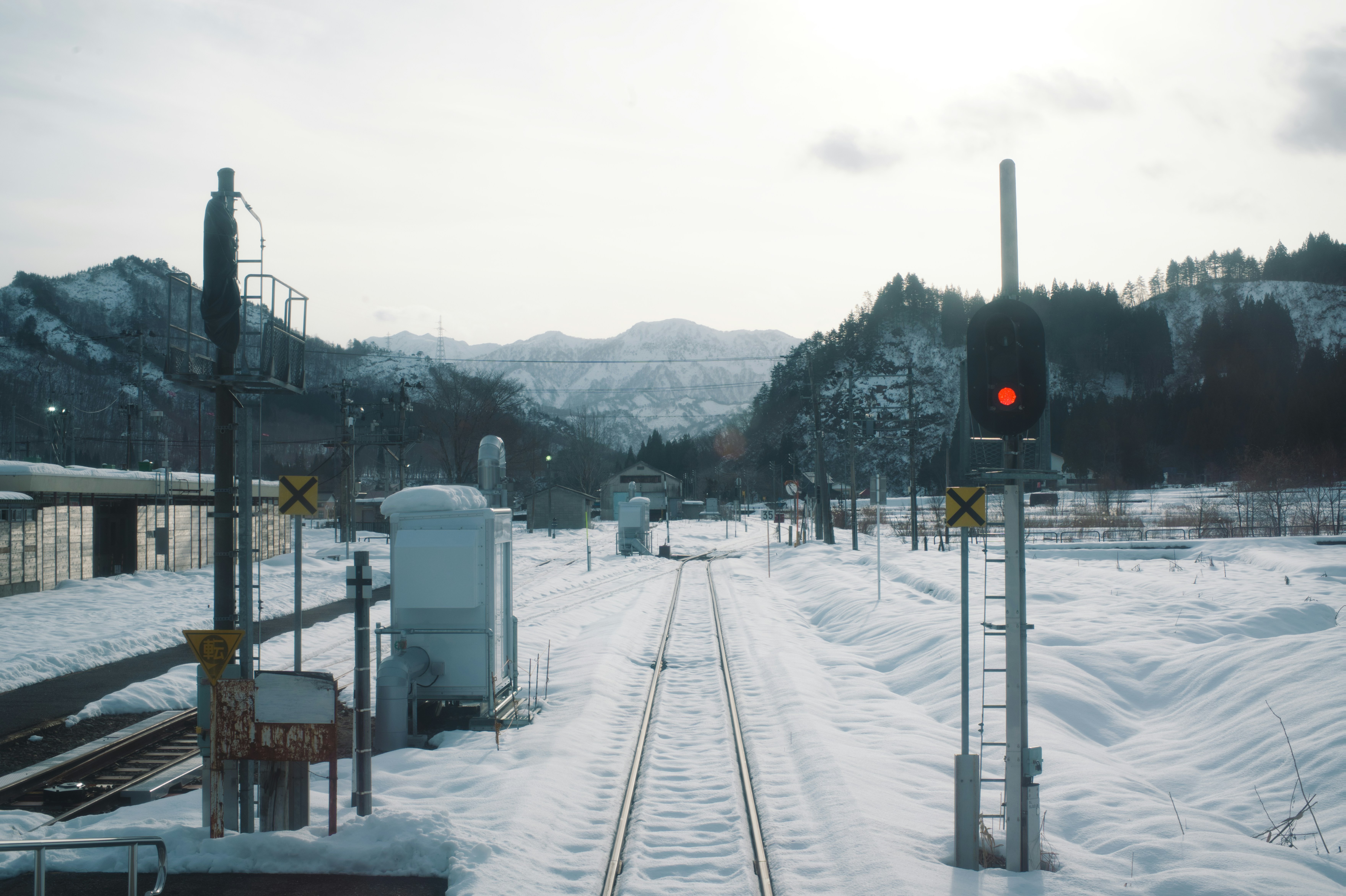 A train track in the middle of a snowy field