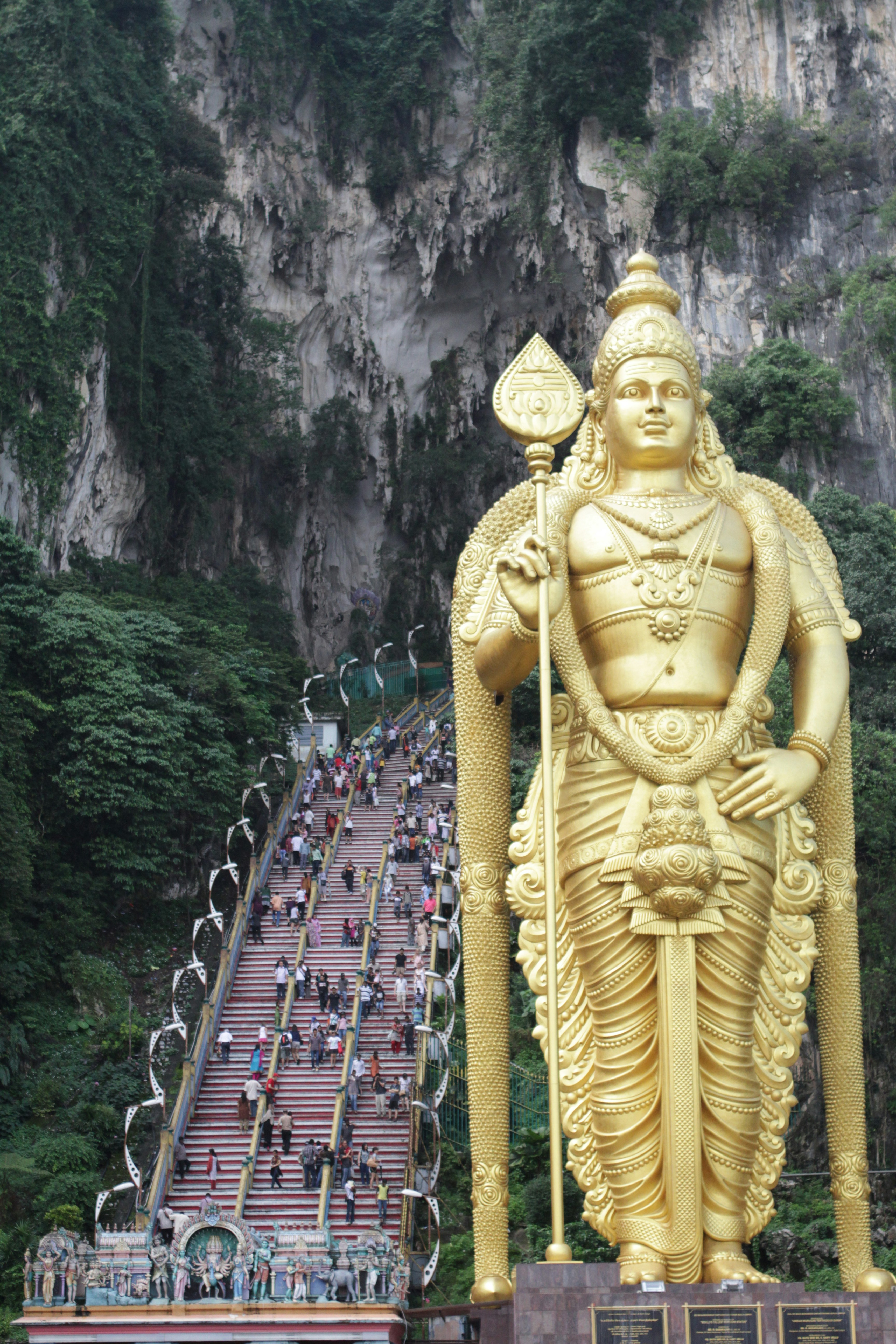 A large golden statue of a man holding a staff