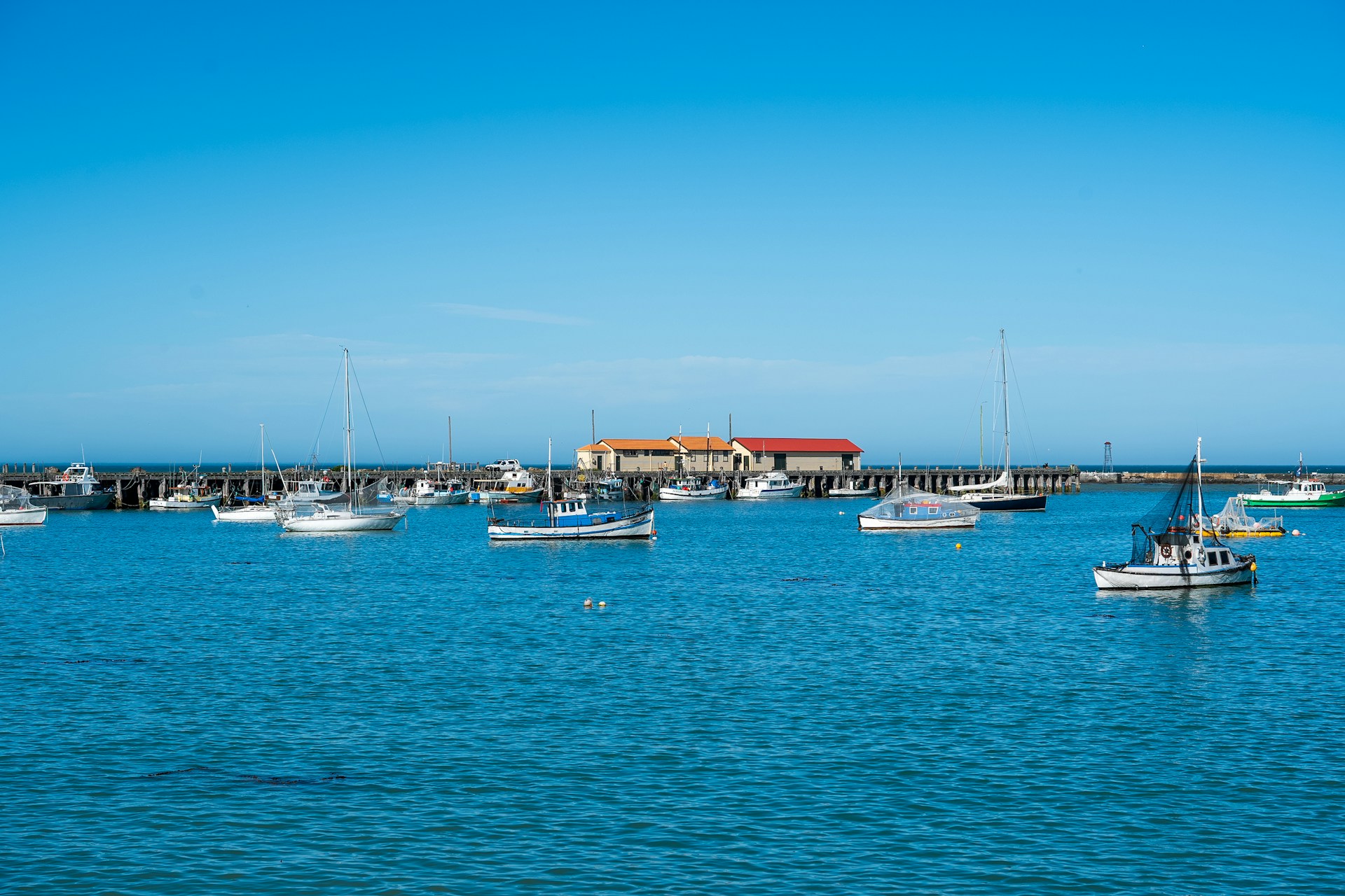 A group of boats floating on top of a body of water