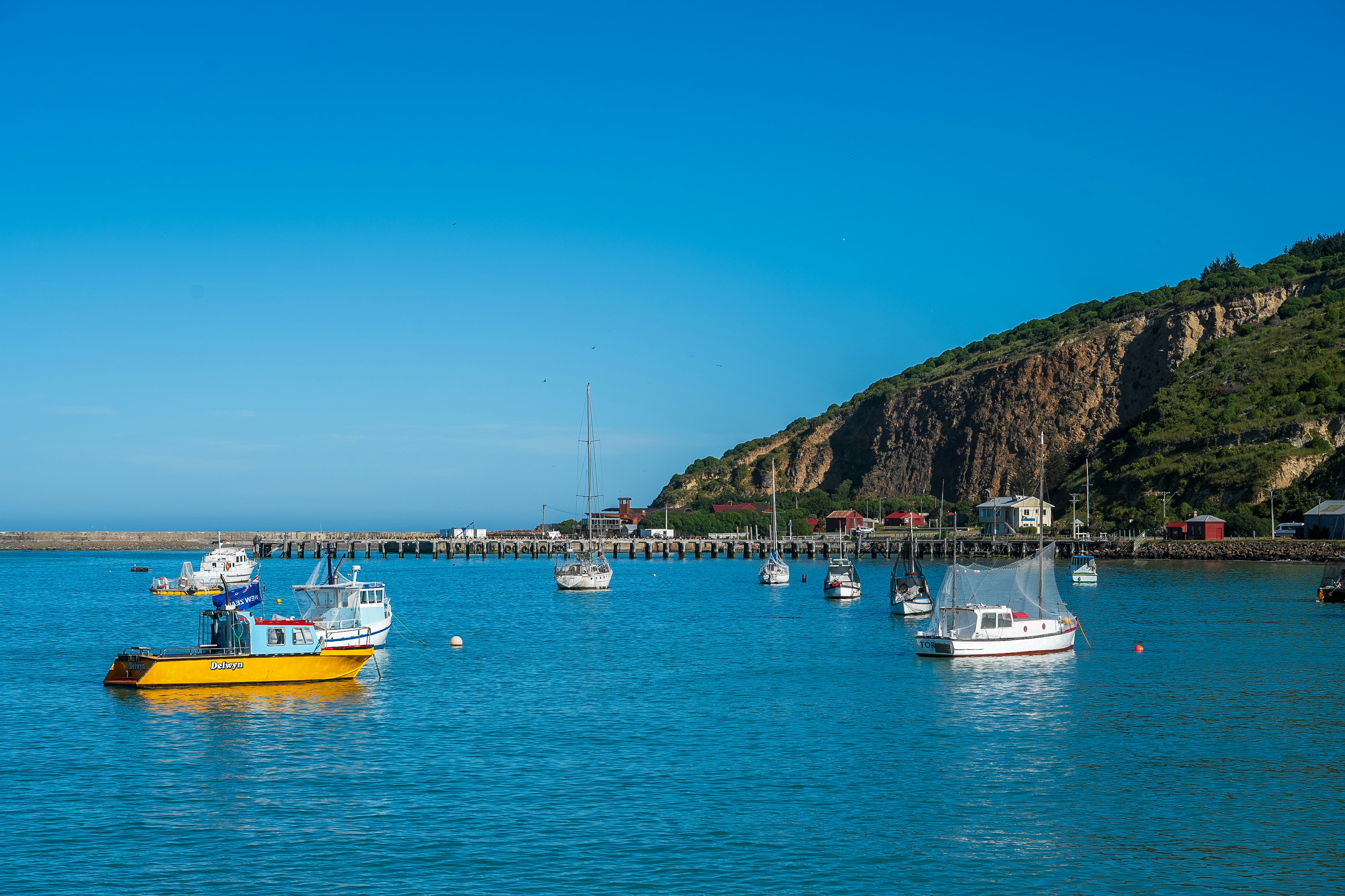 A group of boats floating on top of a body of water