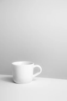 A white cup sitting on top of a table
