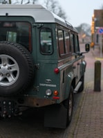 A green vehicle parked on the side of the road
