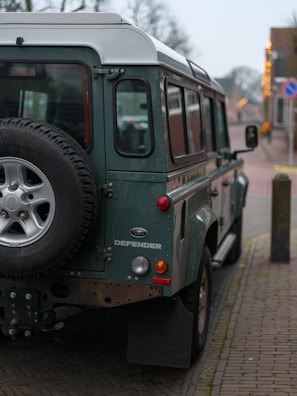 A green vehicle parked on the side of the road