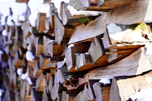 A close up of a wooden fence with snow on it