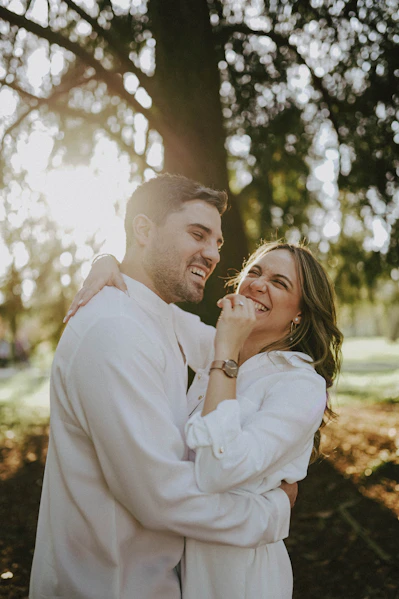 A man and a woman standing in front of a tree