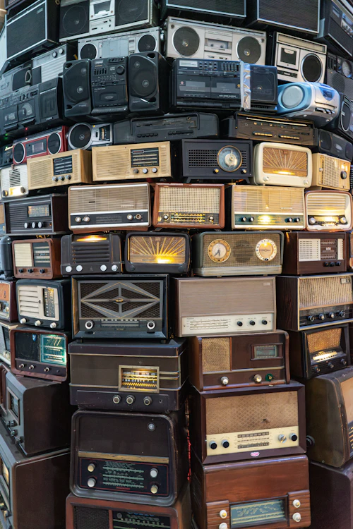 A wall of stacked vintage radios