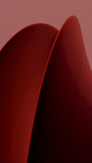A close up of a red object on a pink background