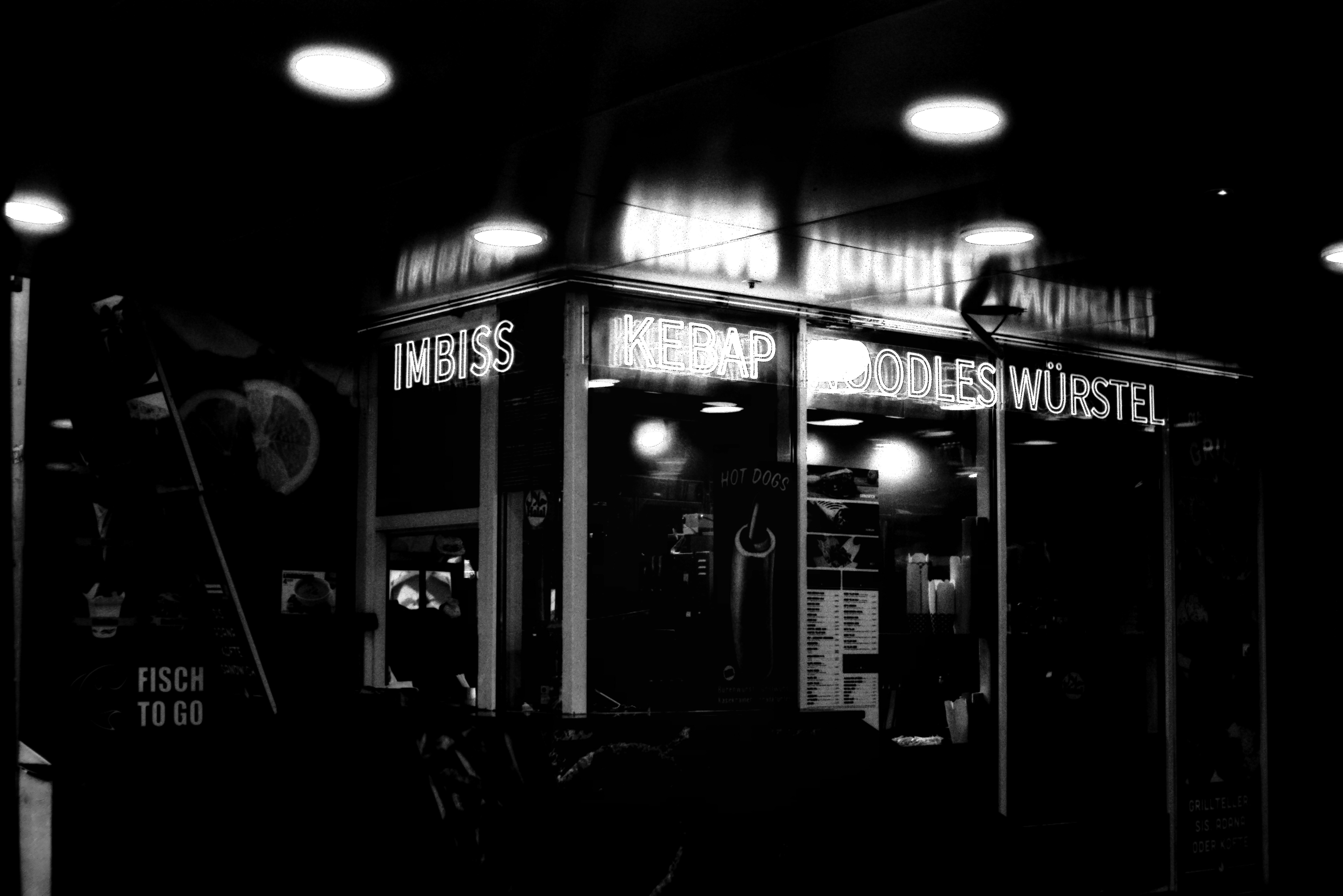 A black and white photo of a building at night