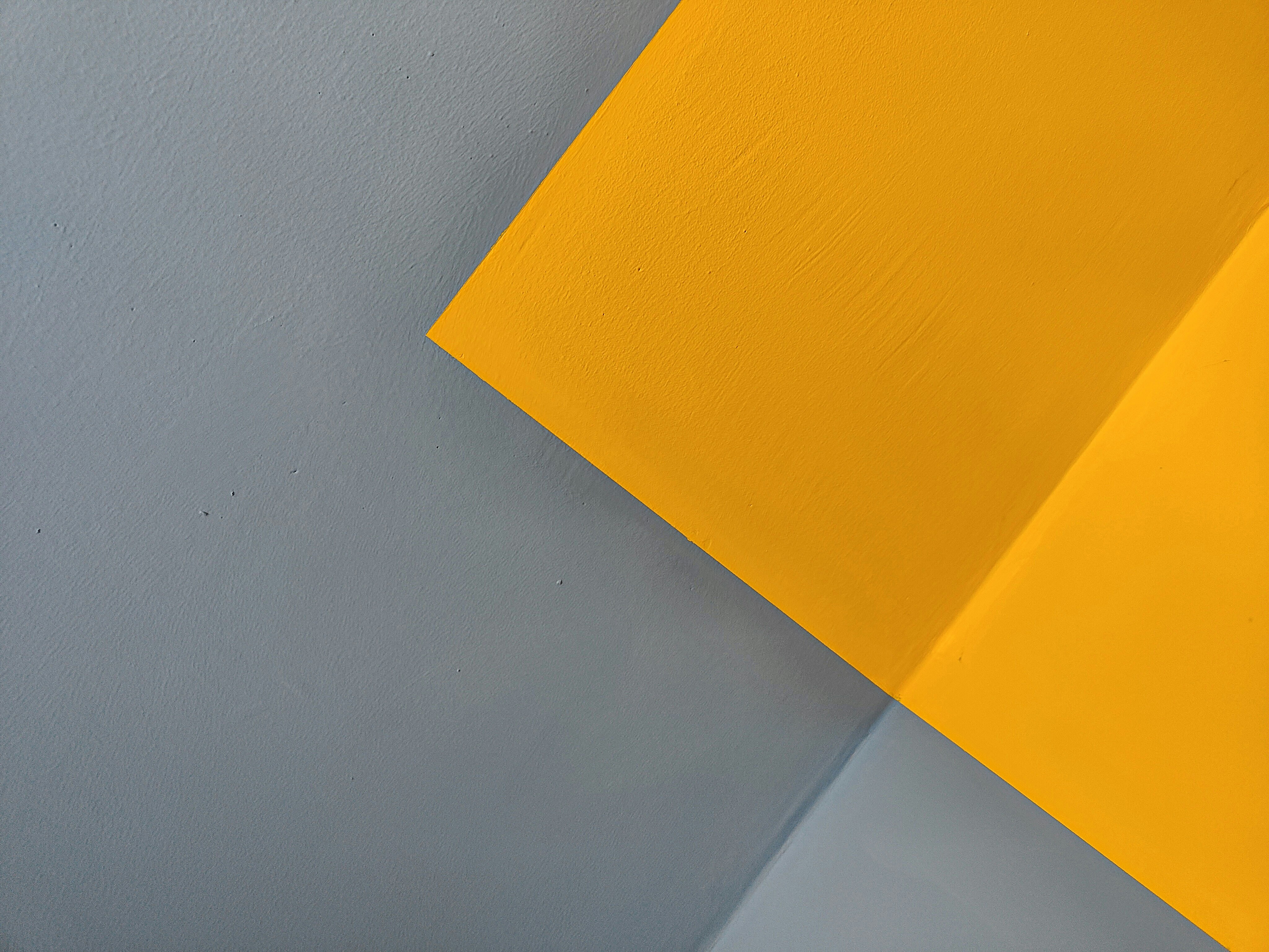 A close up of a yellow and gray wall