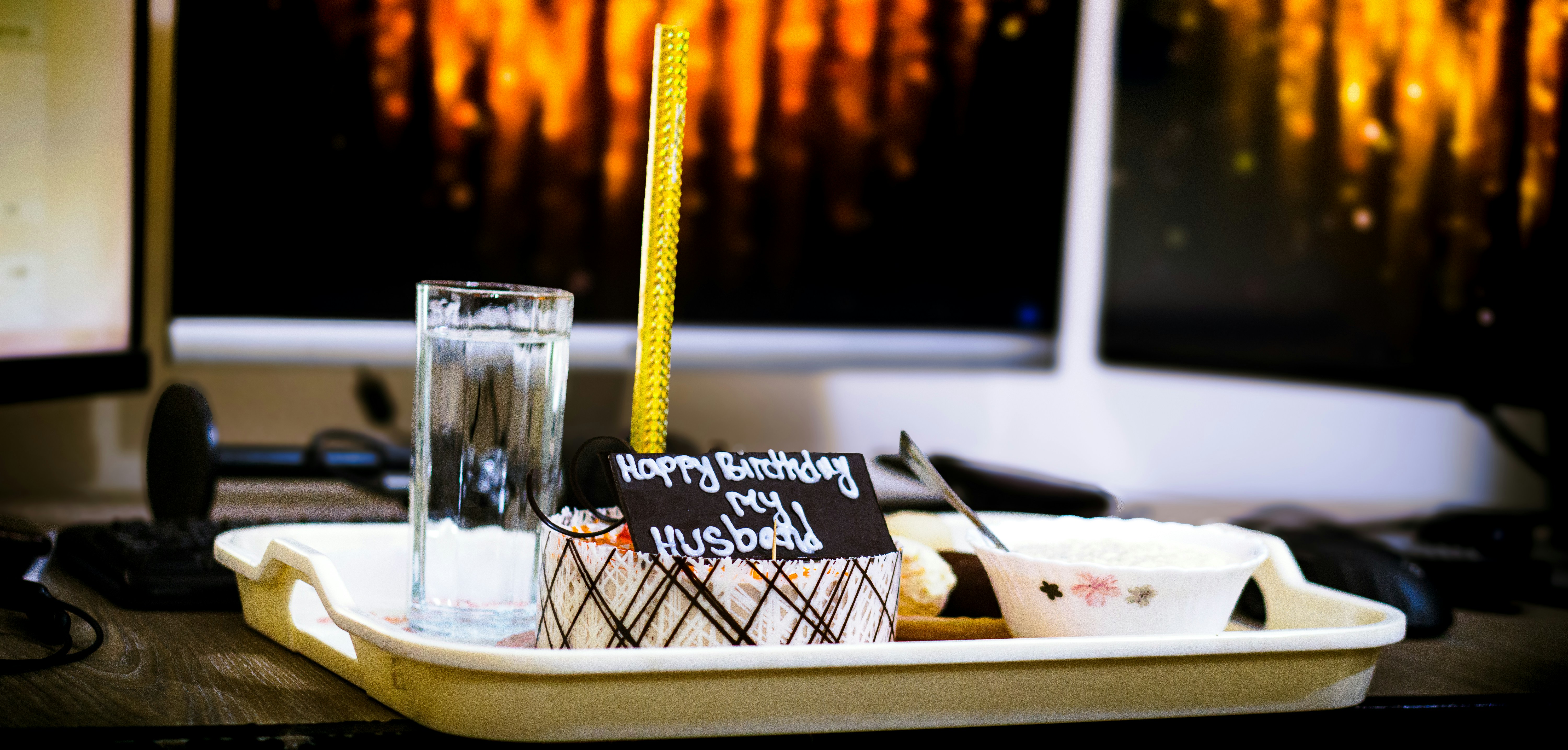 A desk with a computer and a candle on it