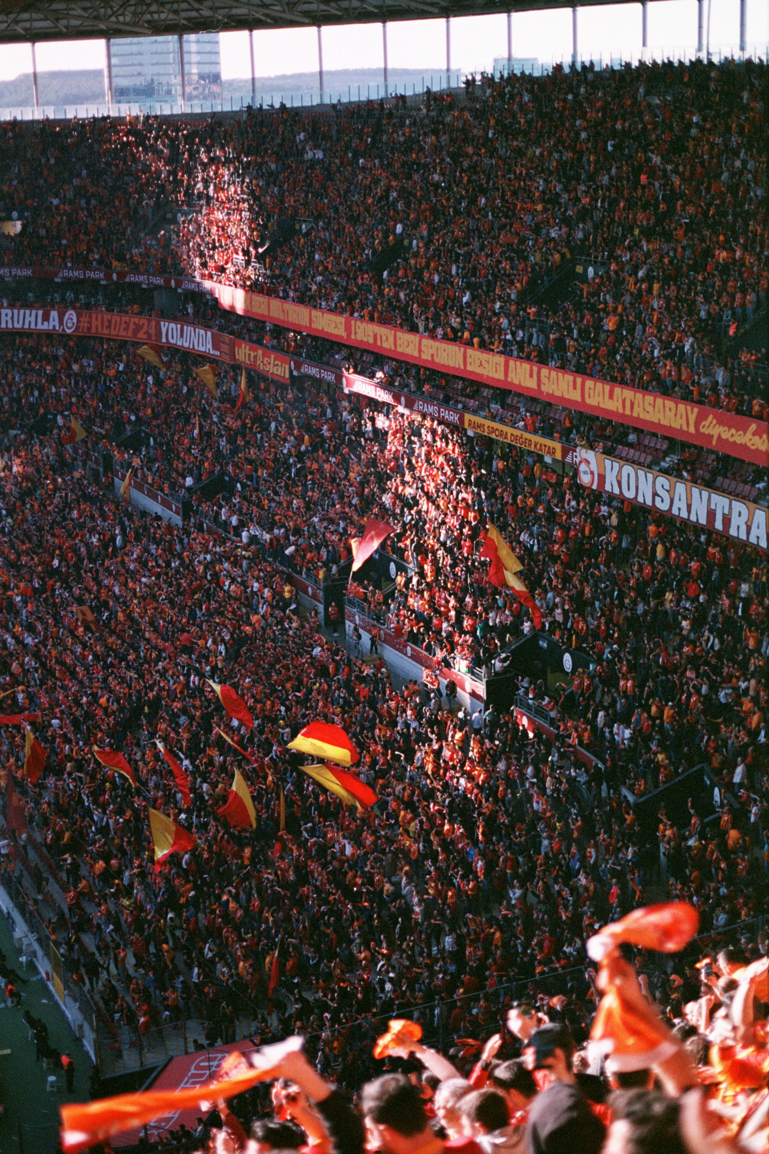 Crowd of football fans with multiple flags celebrating