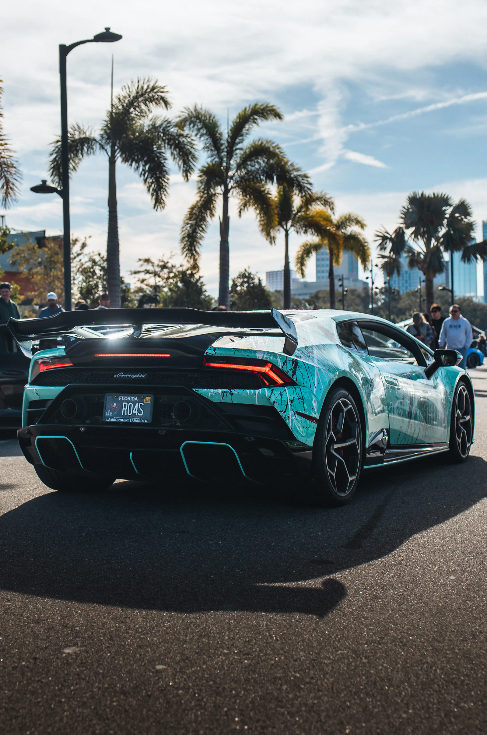 A supercar on a palm-lined street