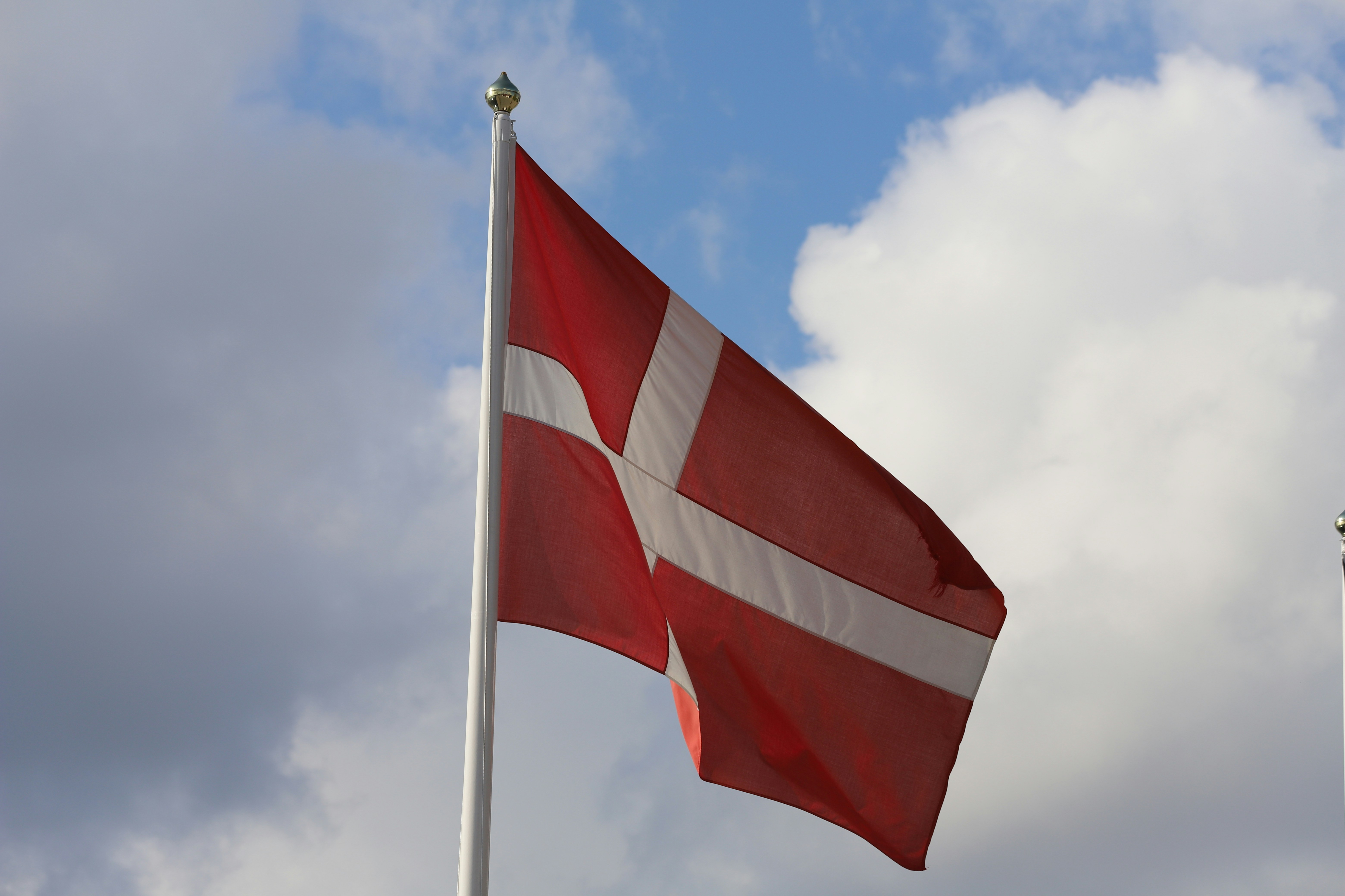 A red and white flag flying in the wind