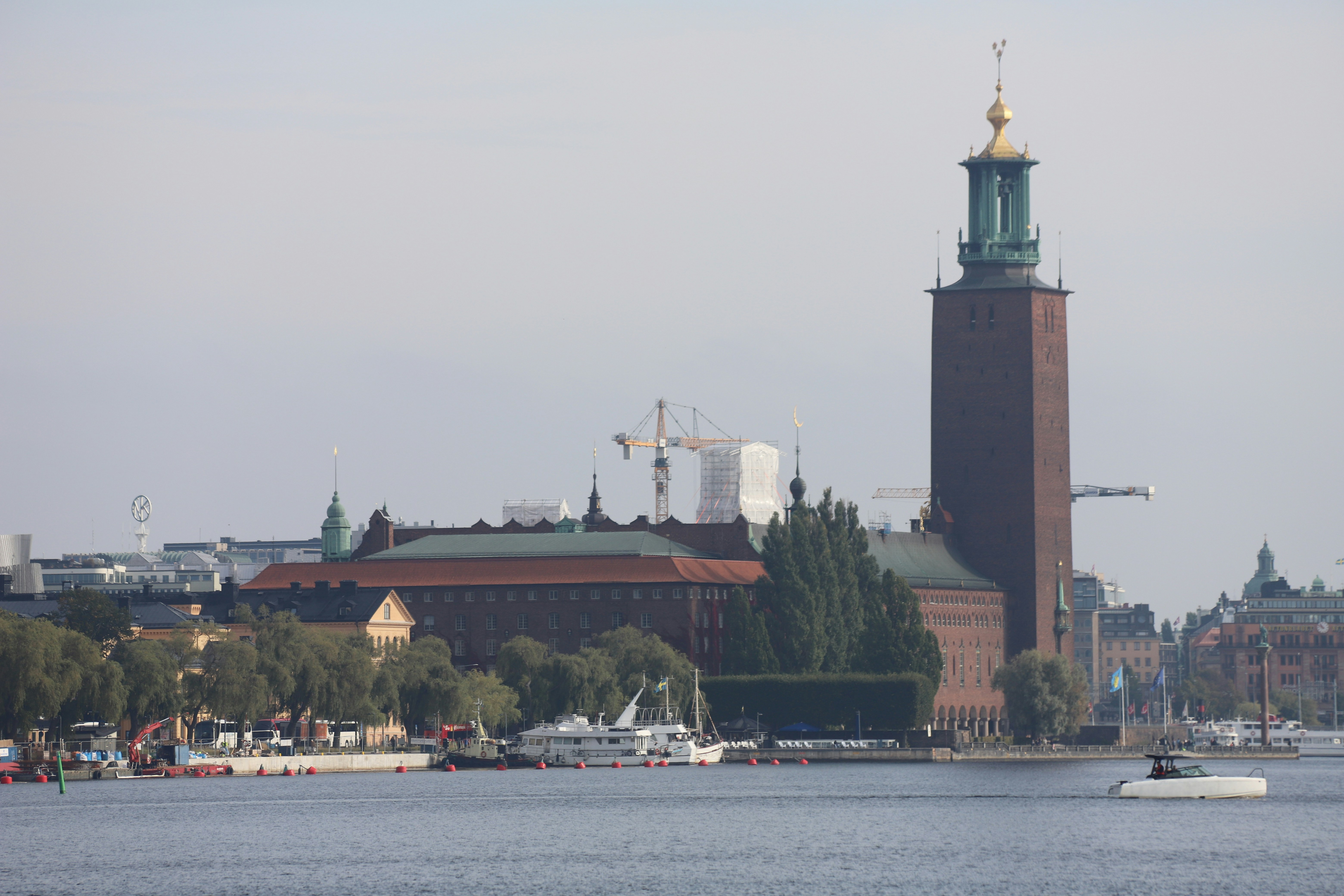 A body of water with a clock tower in the background