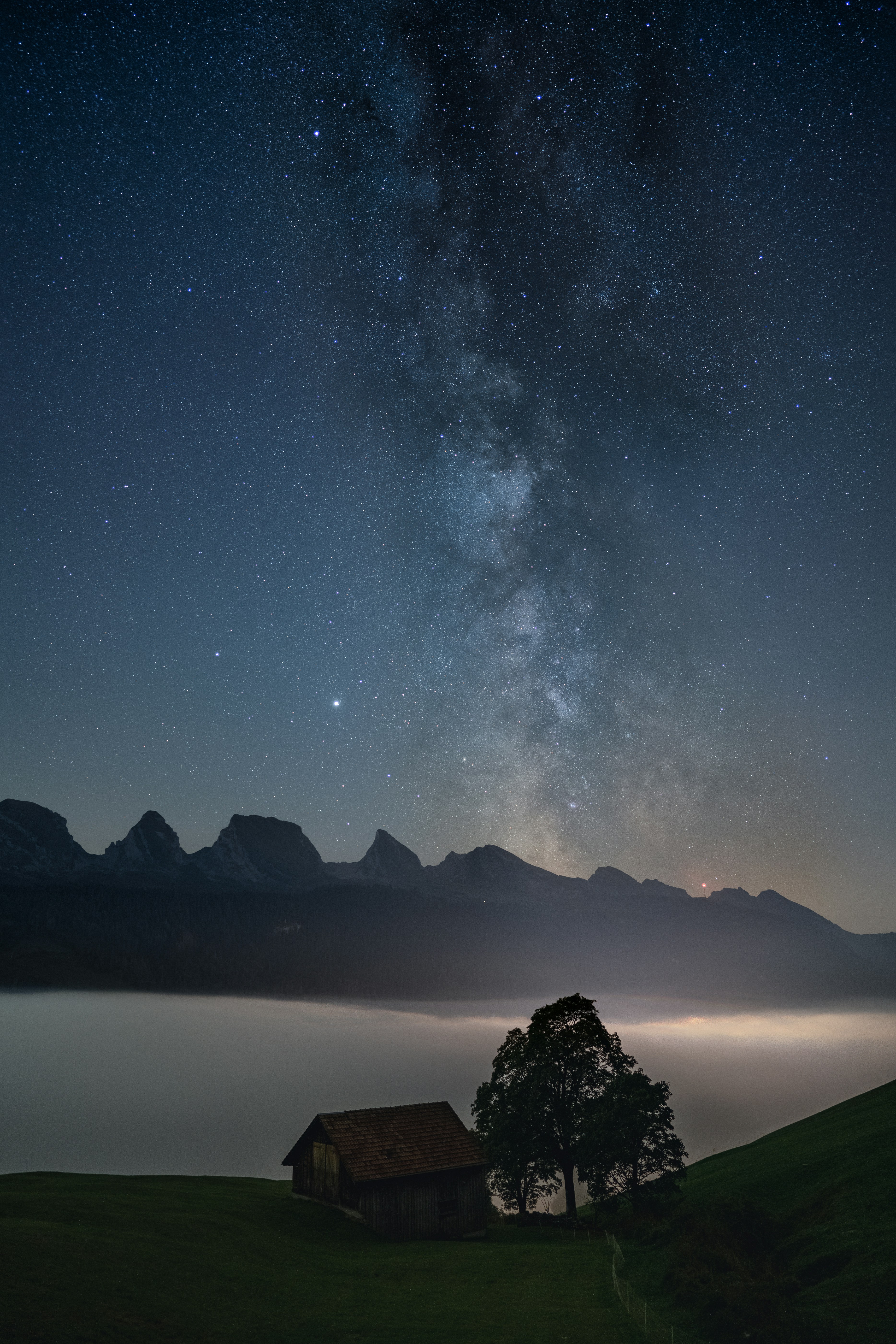 A house on a hill under a night sky