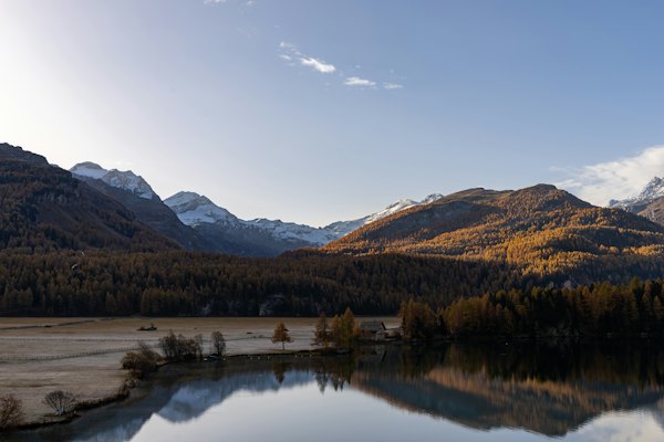 A lake surrounded by mountains and a forest — St. Moritz, Switzerland
