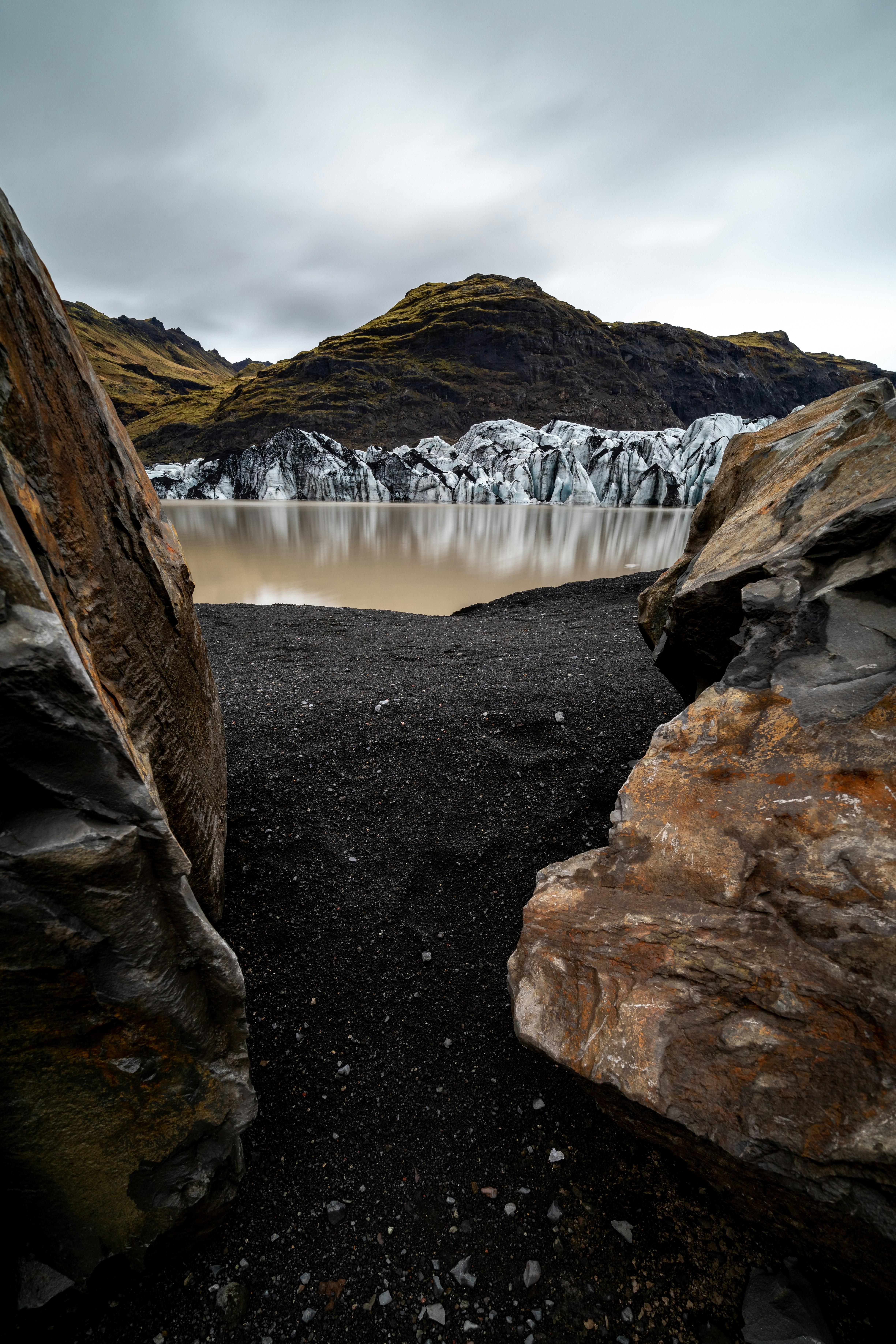 A rocky area with a body of water in the distance
