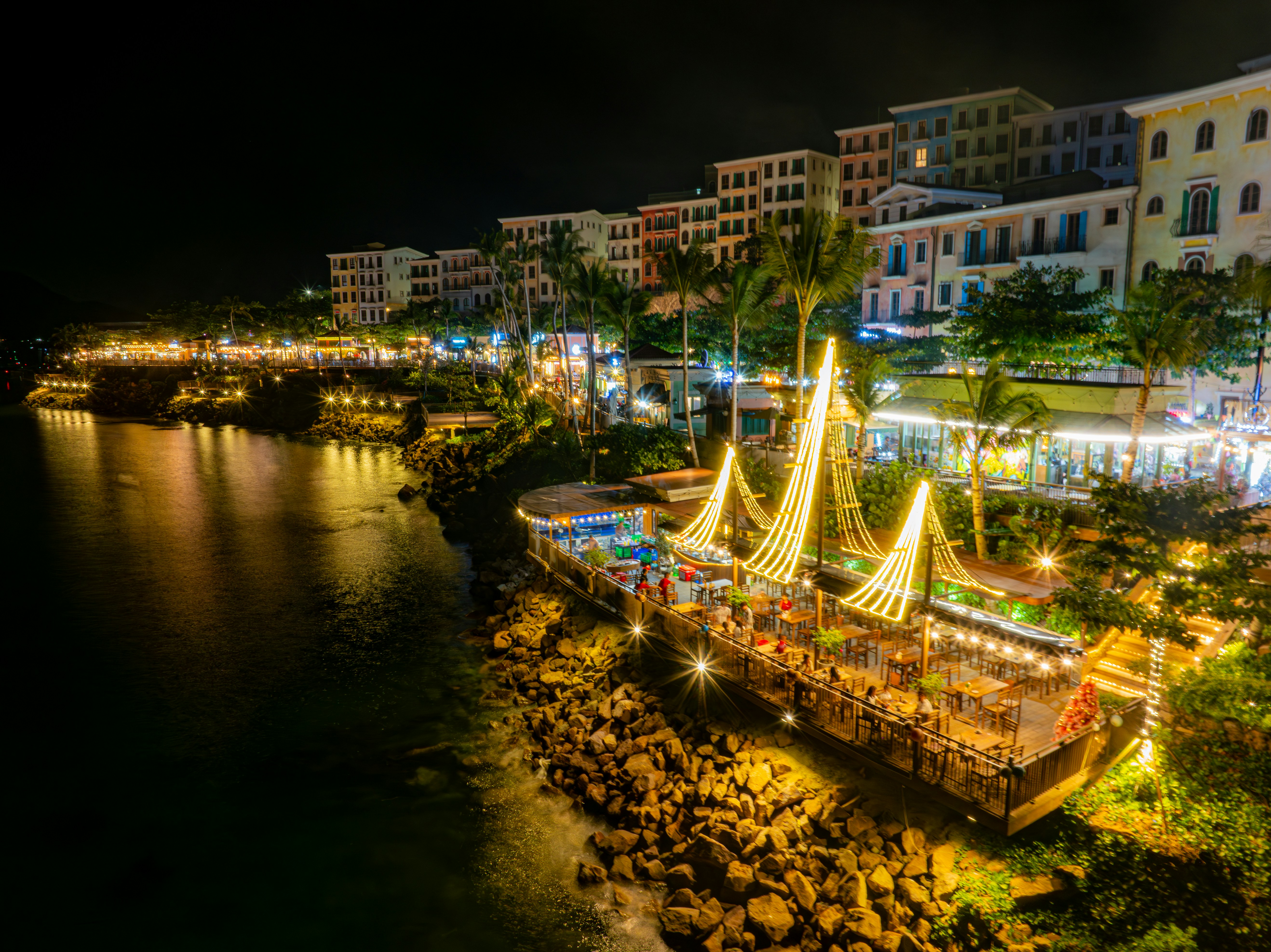 A night time view of a harbor with a boat in the water