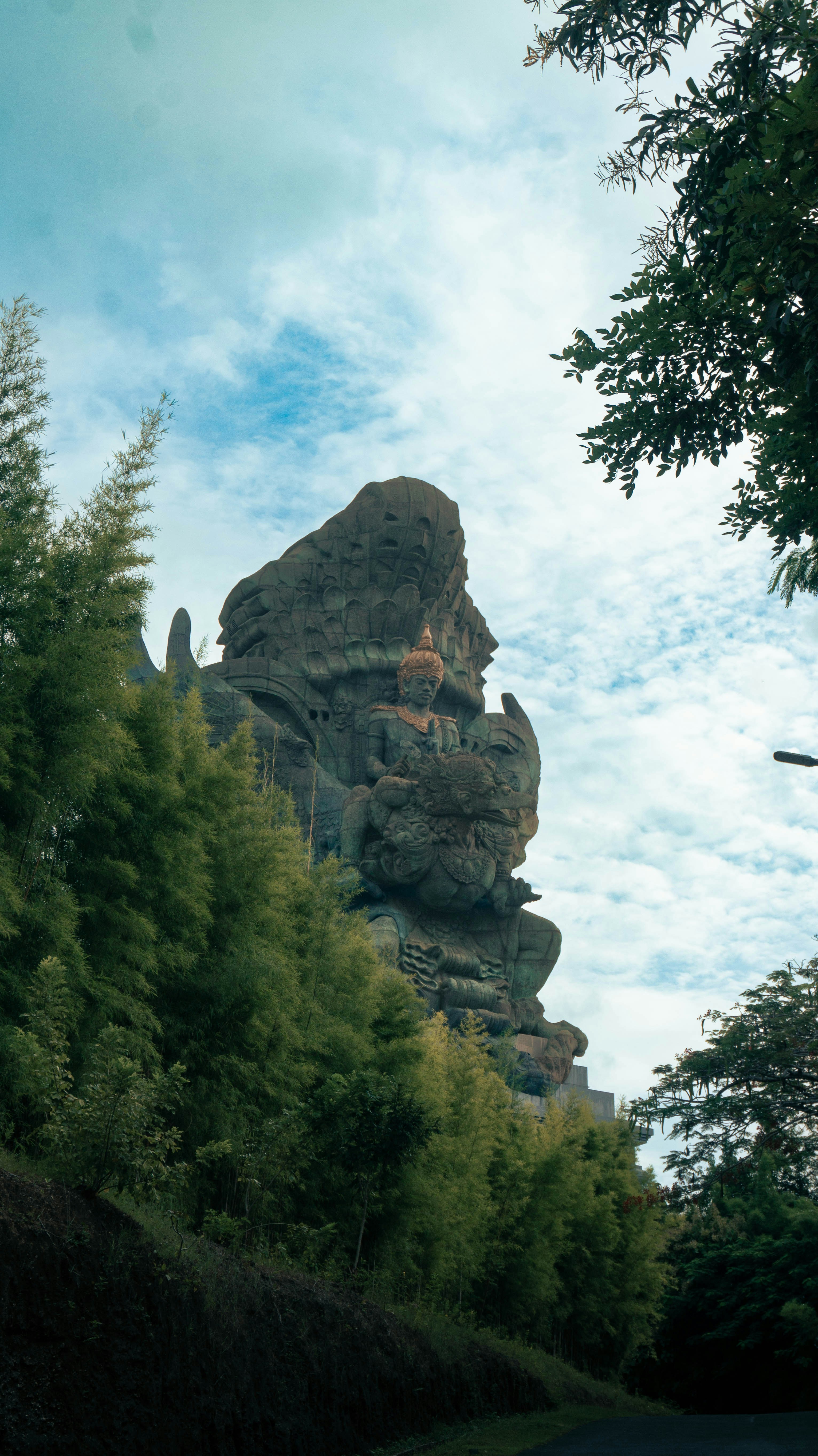 A large rock formation in the middle of a forest