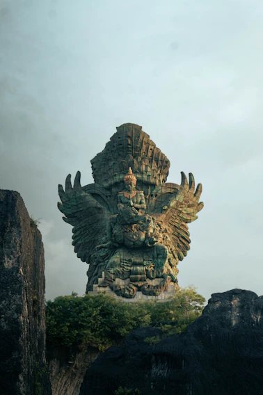 A large statue of a god on top of a mountain