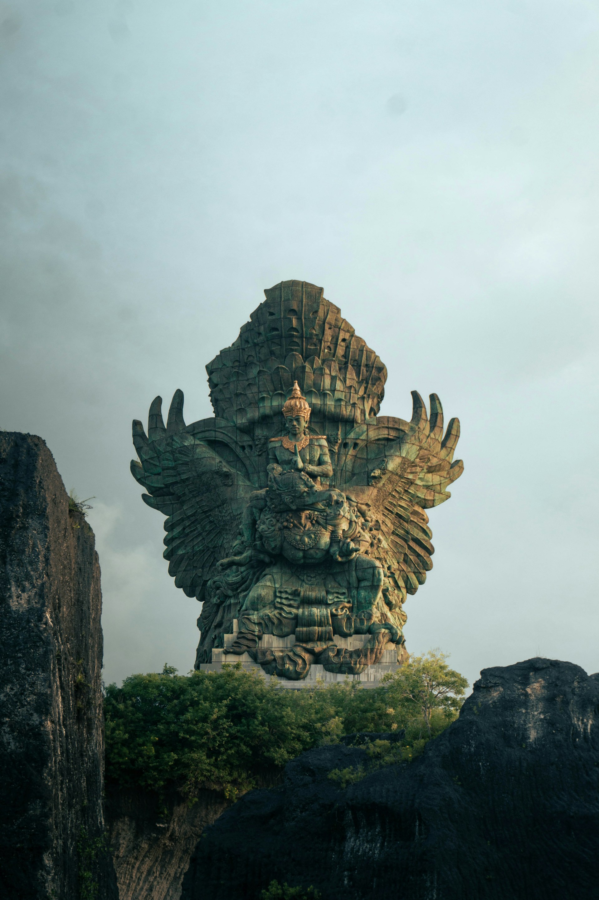 A large statue of a god on top of a mountain
