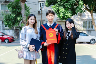 A group of three people standing next to each other