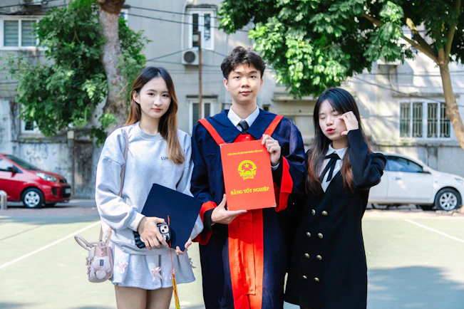 A group of three people standing next to each other