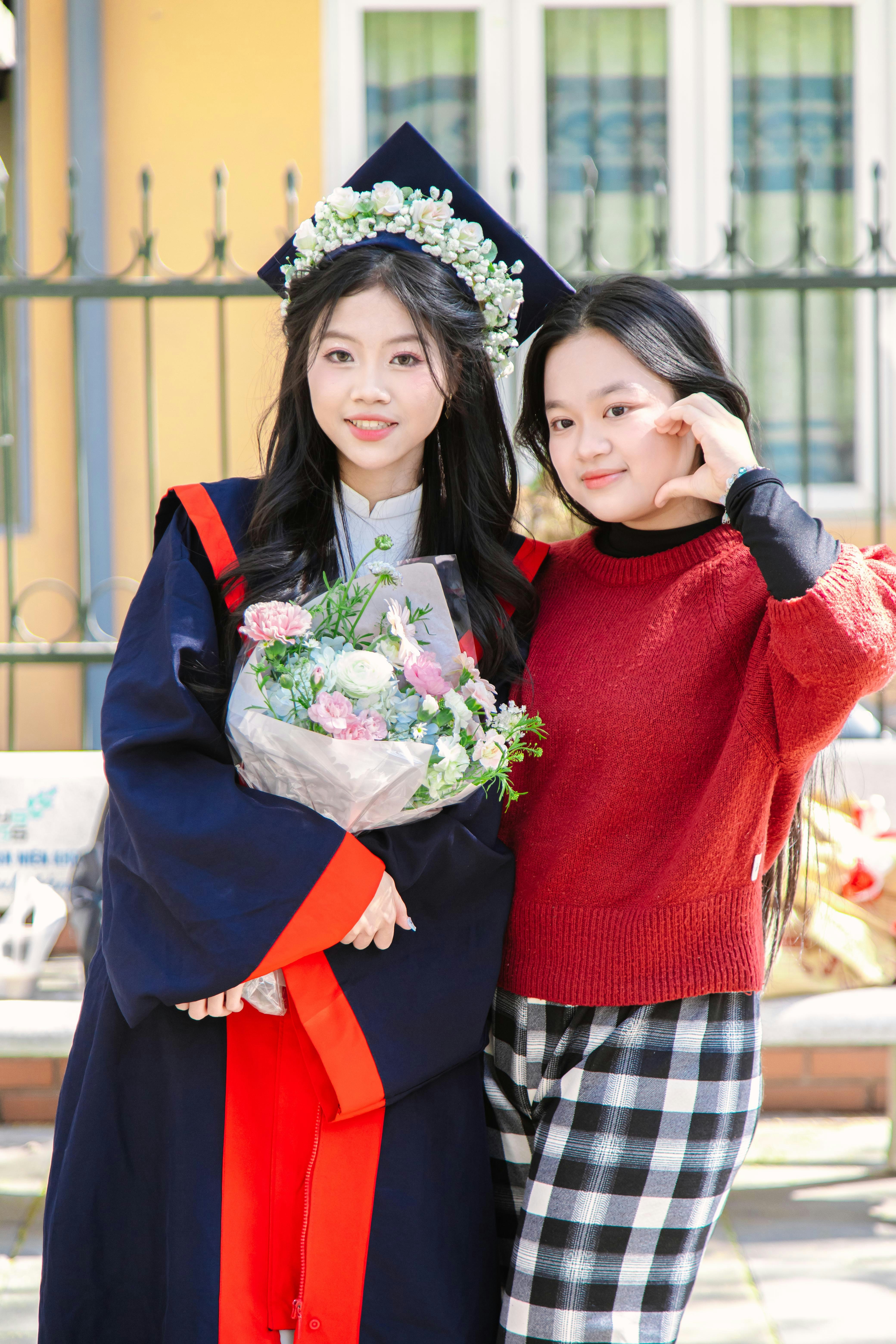 Two young women are posing for a picture
