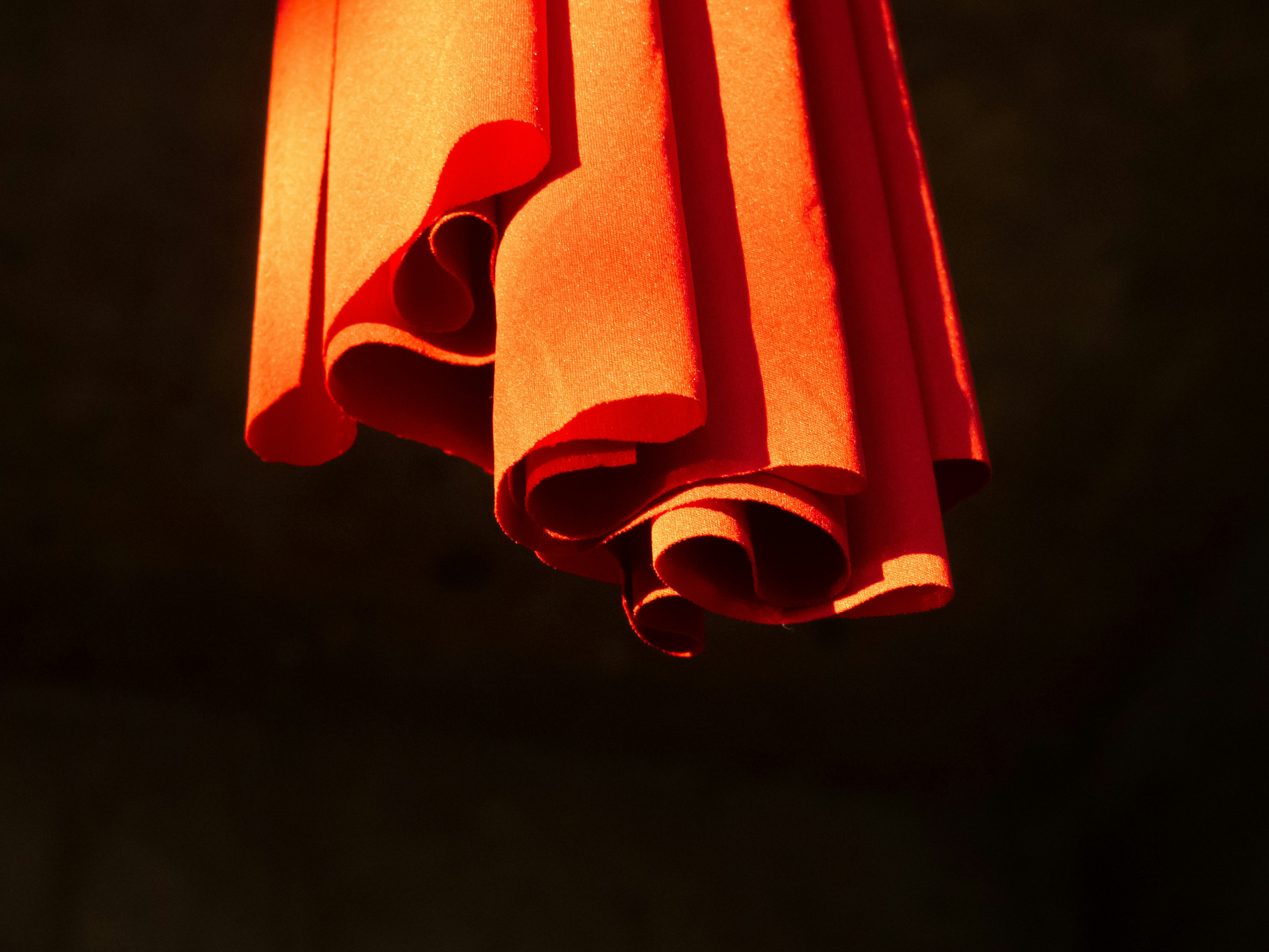 A red light hanging from a ceiling in a dark room