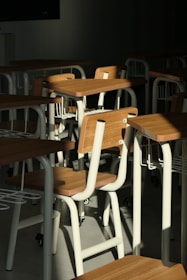 A room filled with lots of wooden desks and chairs