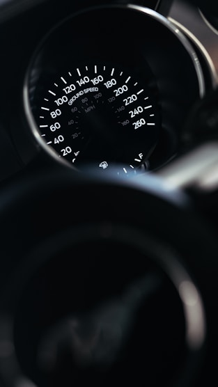 A close up of a speedometer in a car