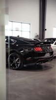 A couple of cars parked inside of a building