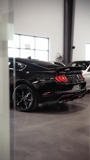 A couple of cars parked inside of a building