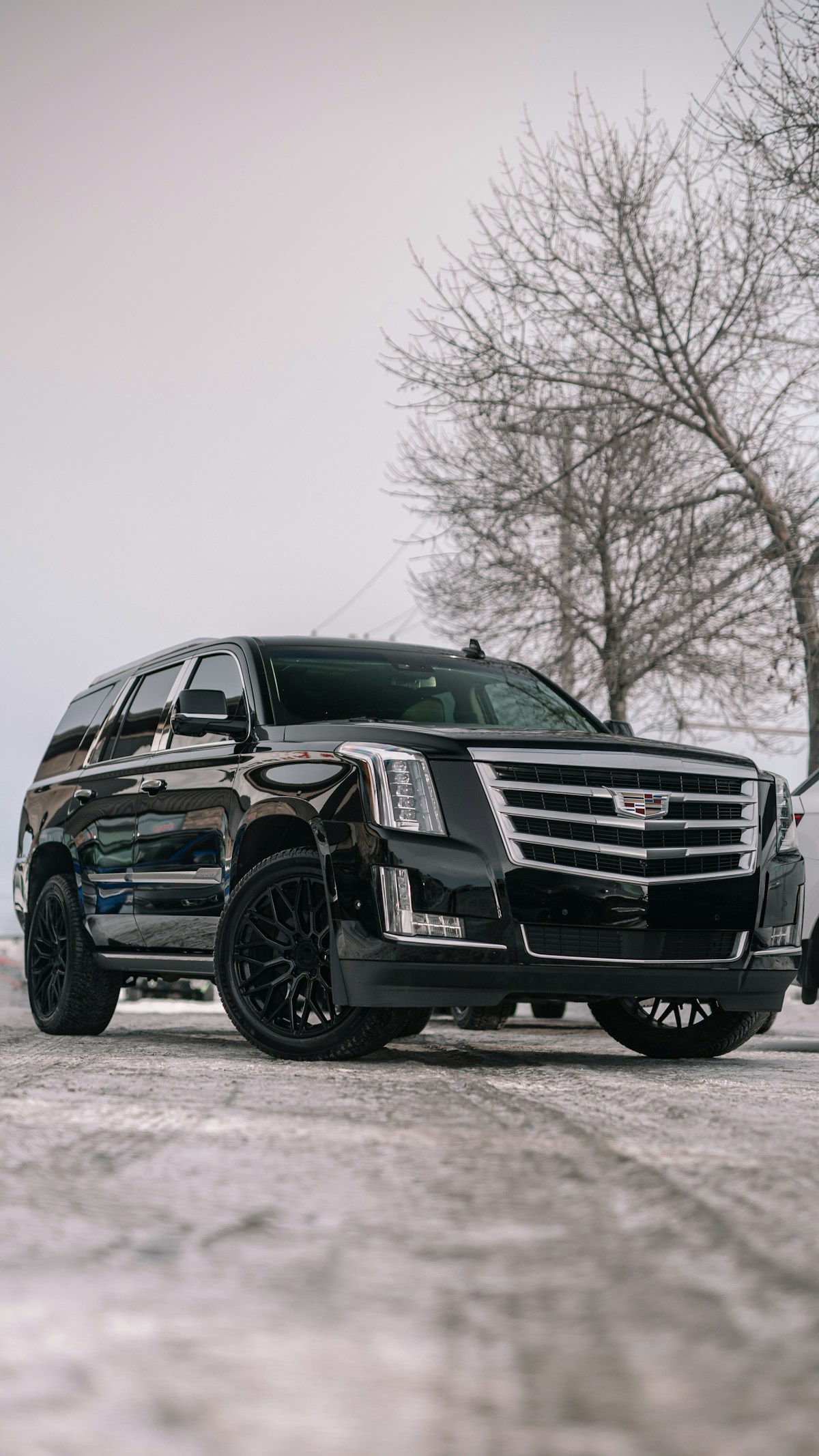 Black Cadillac parked in a parking lot
