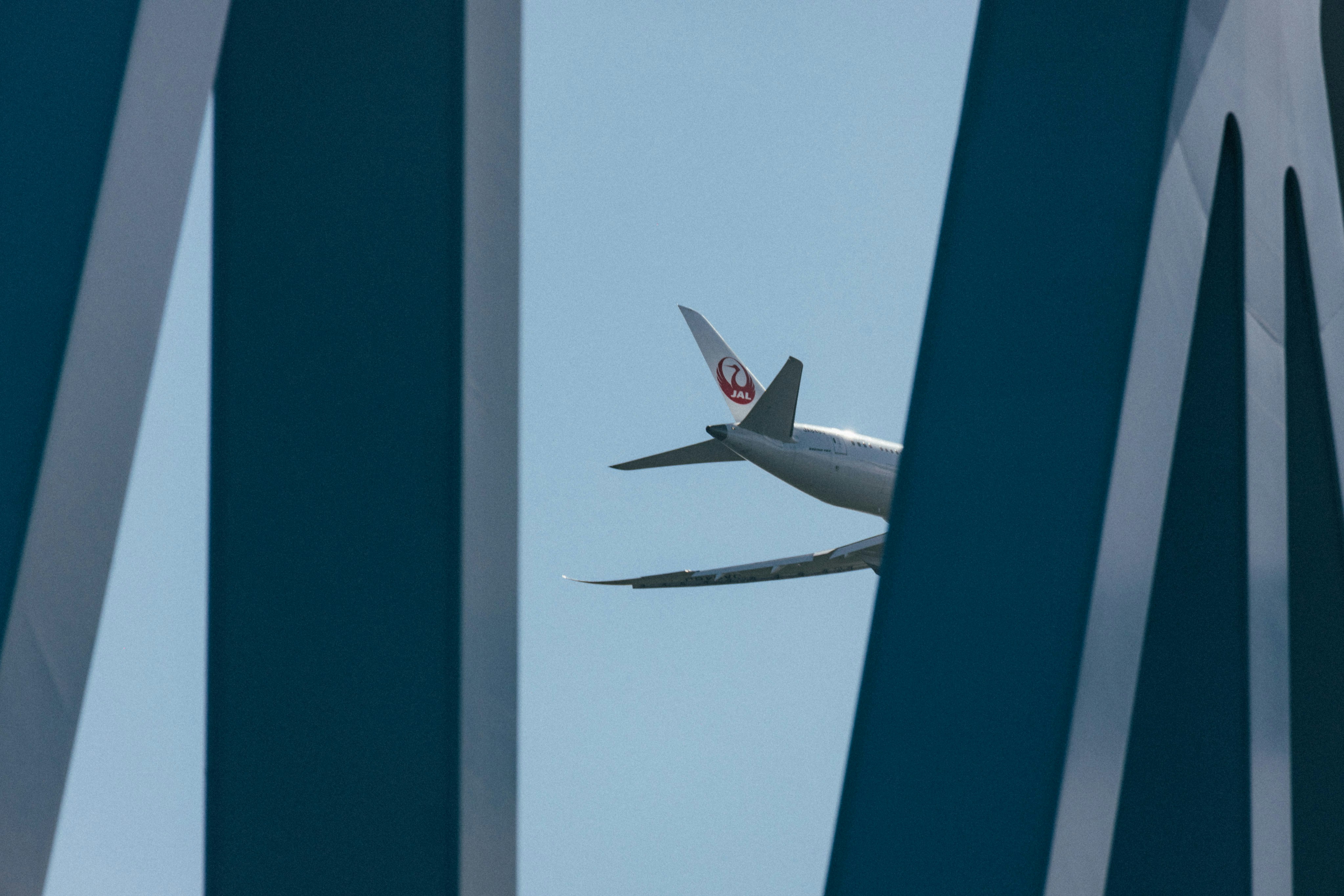 An airplane is flying through the blue sky, 