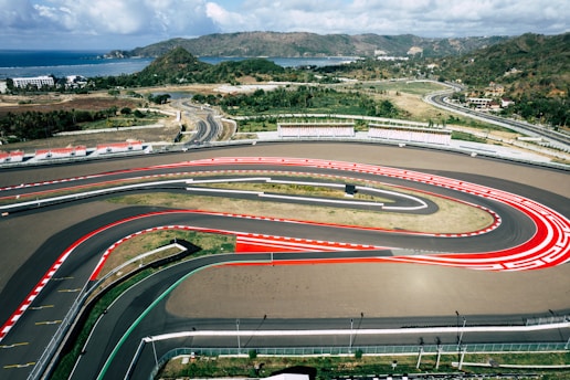 An aerial view of a race track with cars on it