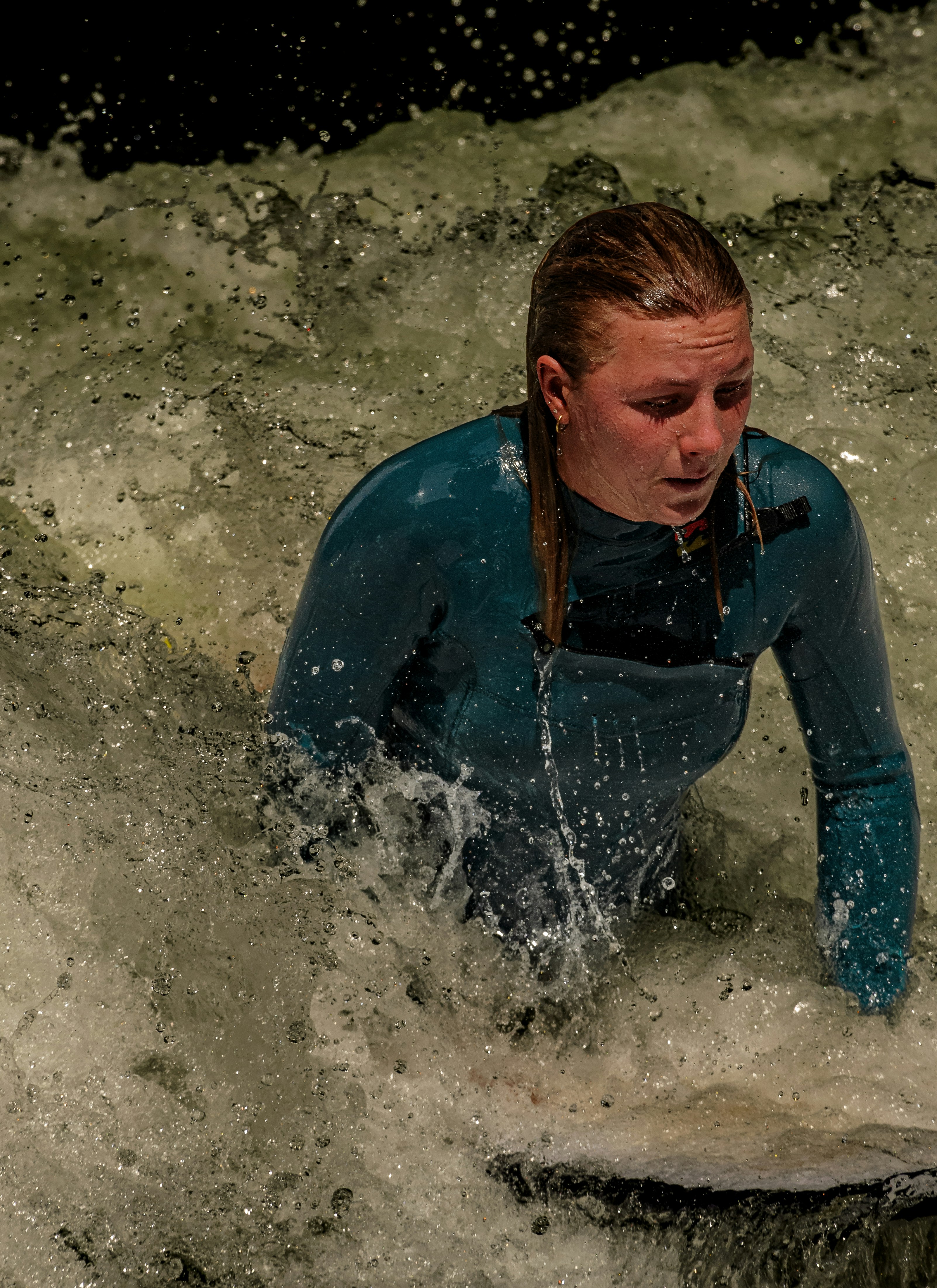 A woman riding a wave on top of a surfboard
