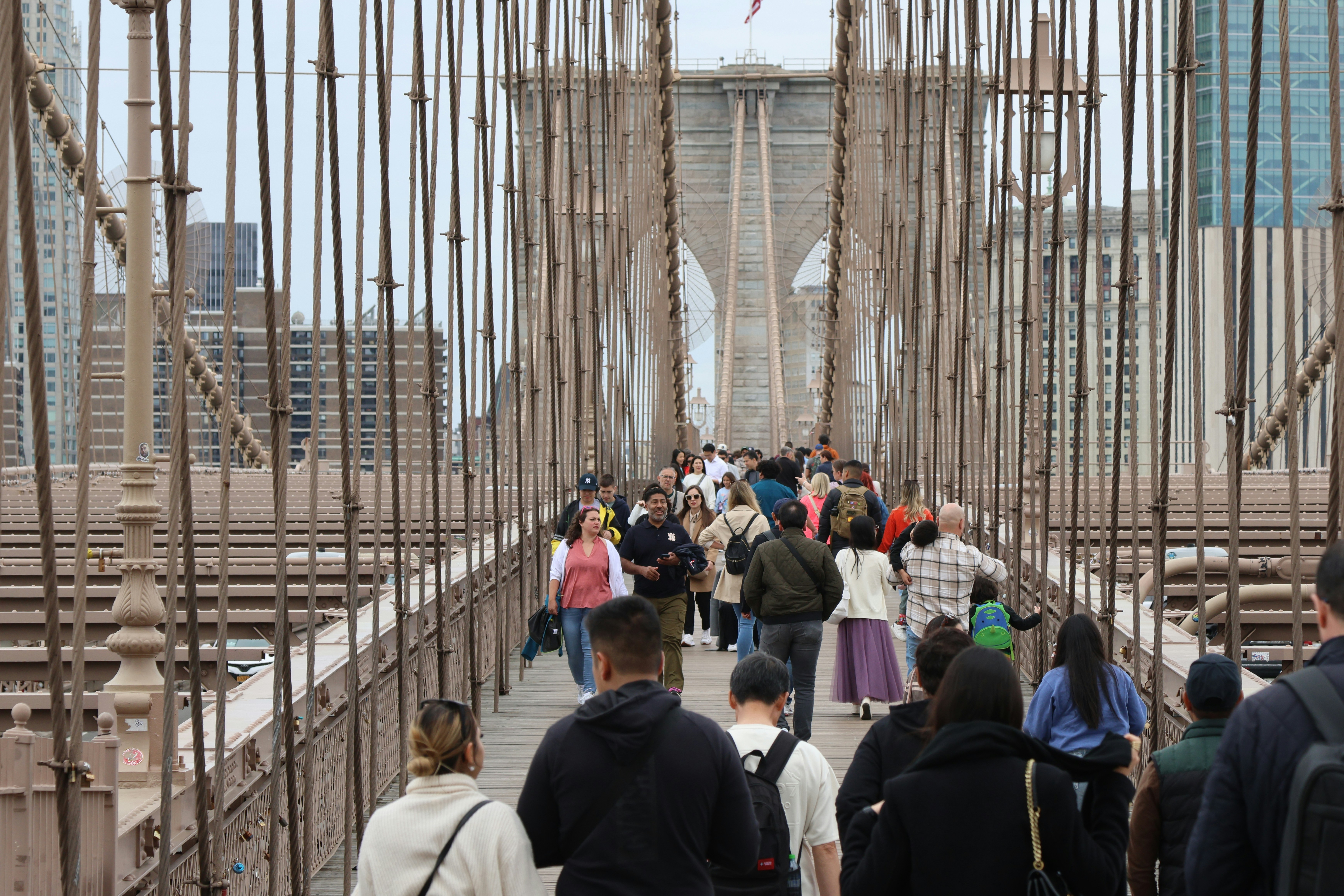 A group of people walking across a bridge