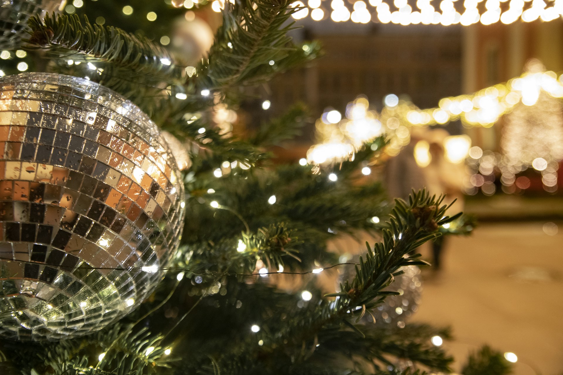 A close up of a christmas tree with a disco ball on it